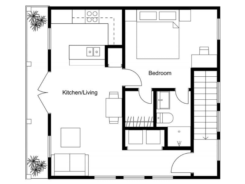 One-bedroom 2D floor plan of the lower level of a two-story house with a balcony and an L-shaped kitchen.