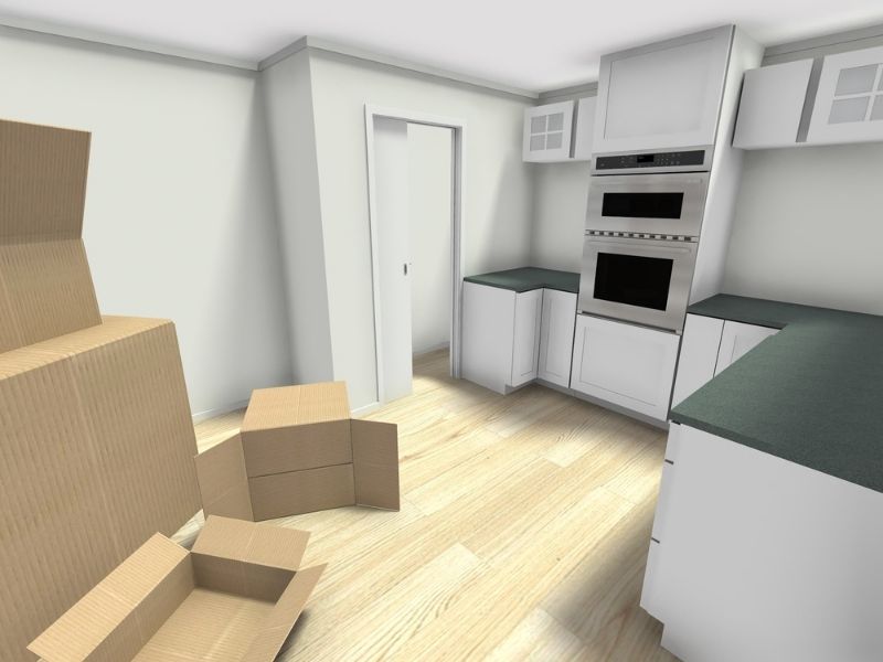 Bare kitchen with cardboard boxes scattered around. For moving or remodeling.