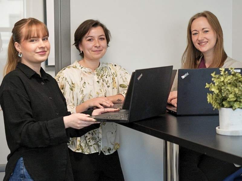Three of our customer support reps posing with their pcs